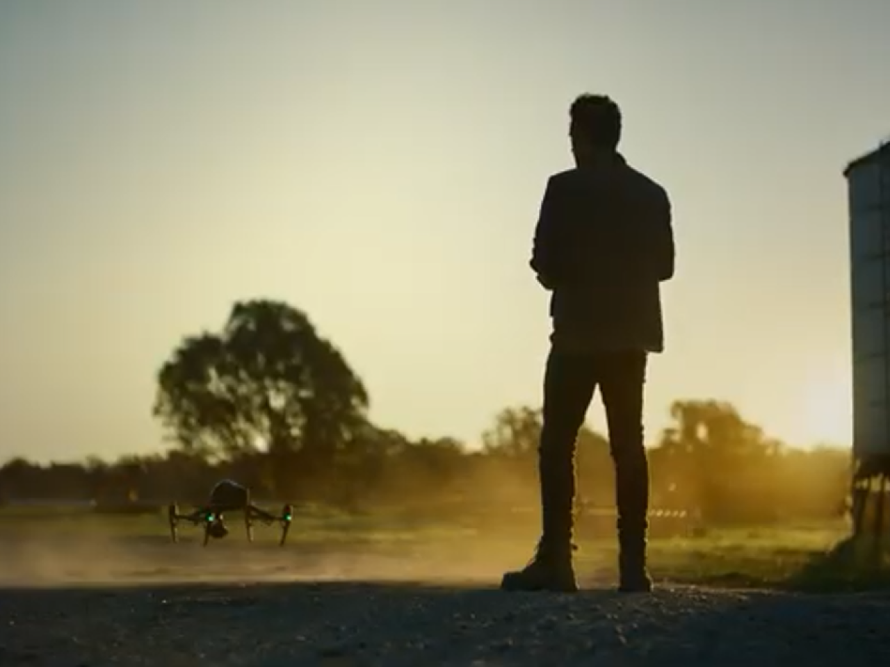 Silouette of man with flying a drone