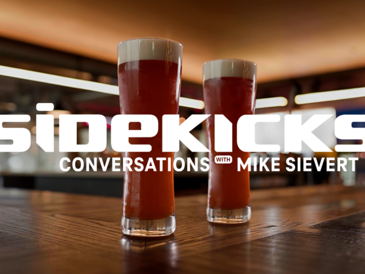 Glasses of beer with text overlaid that reads, "Sidekicks: Conversations with Mike Sievert"