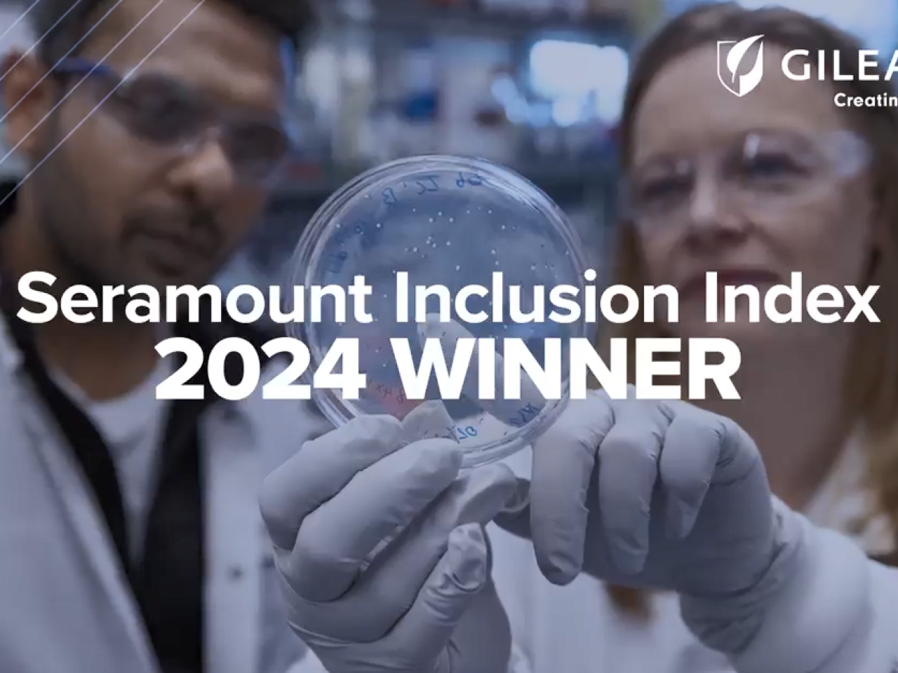 Two people looking at a petri dish that one is holding up. "Seramount Inclusion Index 2024 Winner".