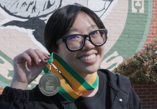 Jackie Li showing award medal