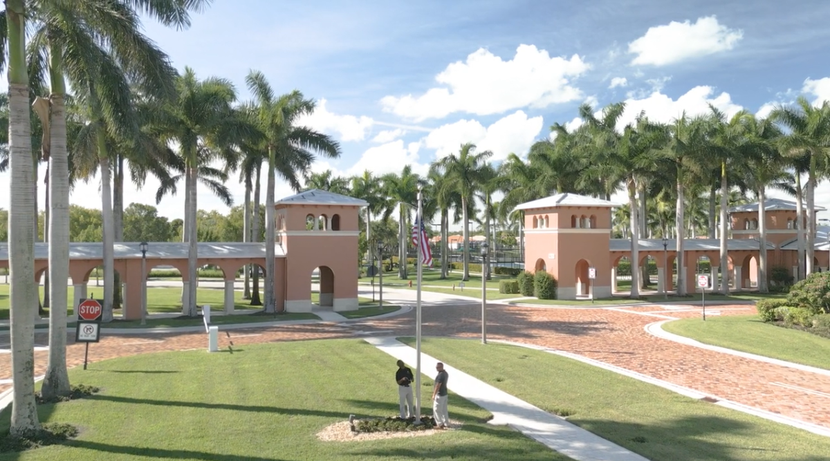 aerial view of two people by a flag pole.