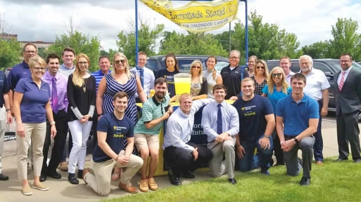 alex's lemonade stand with a group of employees