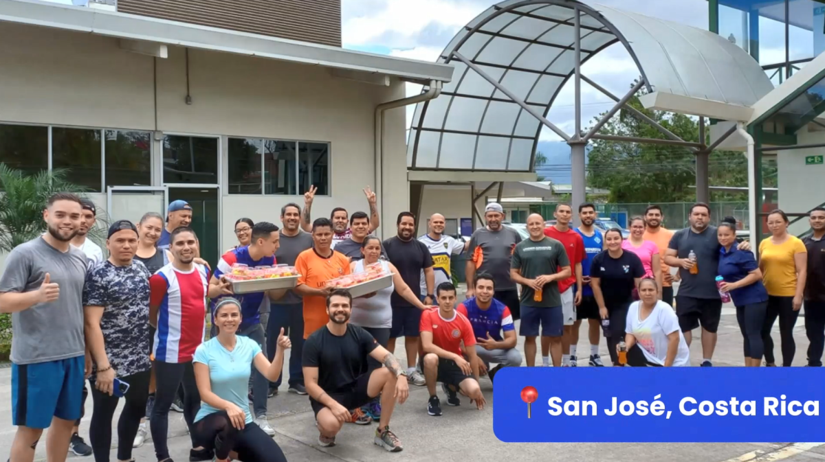 Group of employees posed outside. "San Jose, Costa Rica" in the corner.