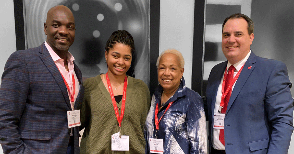 4 people wearing conference name tags