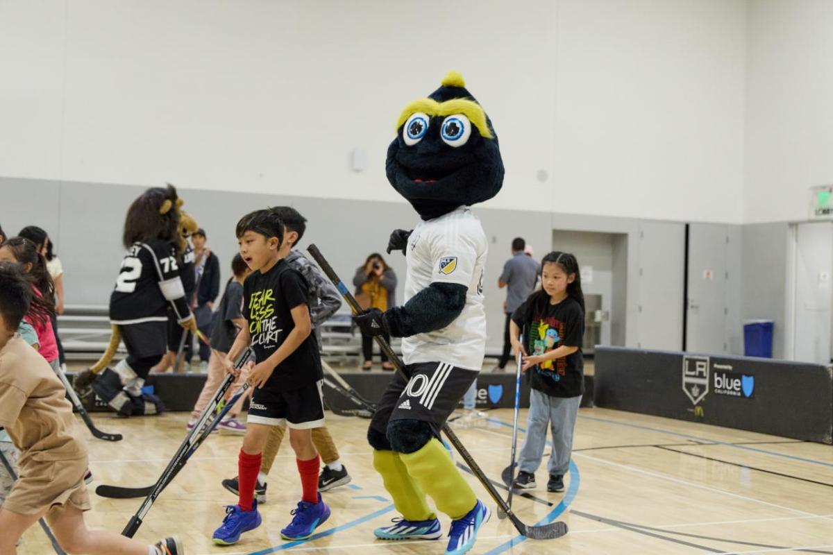 Children from Little Tokyo Service Center play hockey with LA Kings mascot Bailey and LA Galaxy mascot Cozmo.