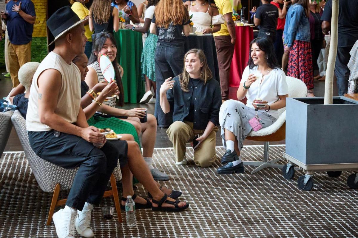 A group of men and woman sitting and talking