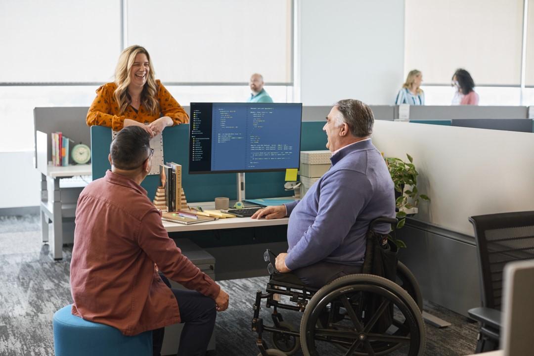 A person standing in front of a person in a wheelchair