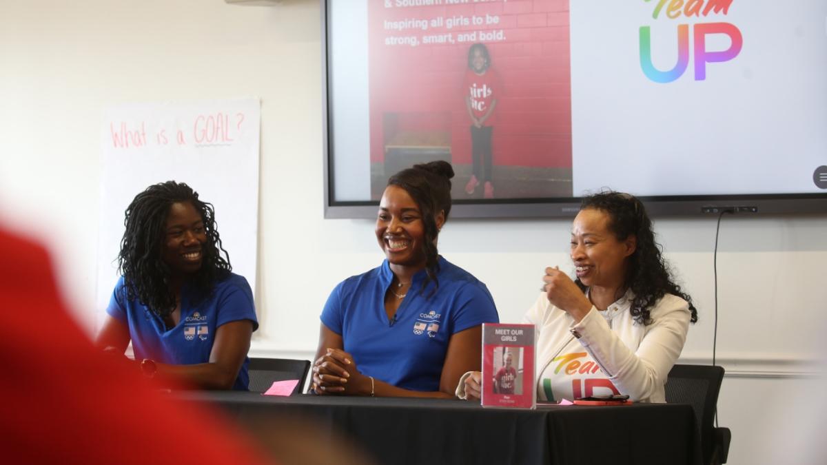 3 people sit at a table fielding questions