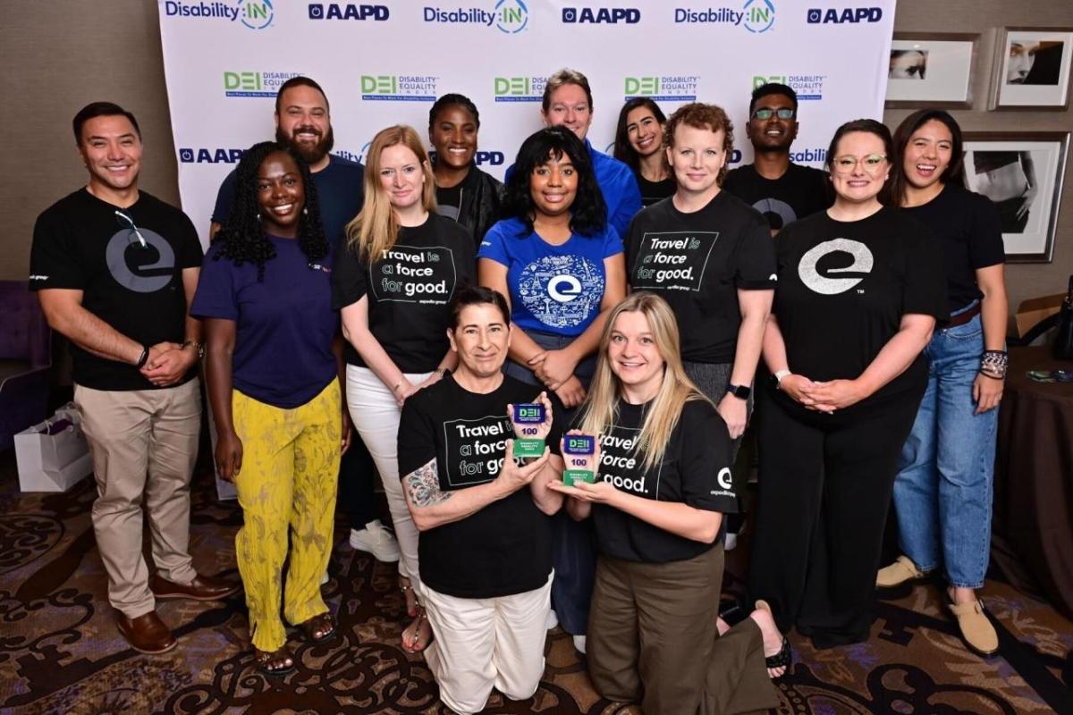 A group photo in front of a Disability:IN Conference back drop 