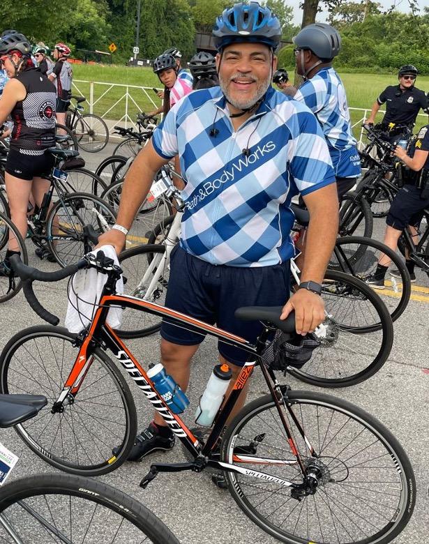 Terrance Hudson, Senior Manager of Store Optimization, stood with a bicycle