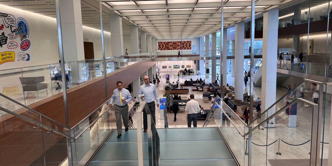 People on an escalator inside a building