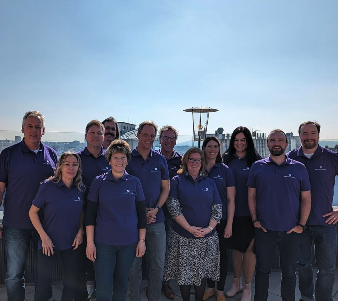 Employees wearing purple, in a group outside