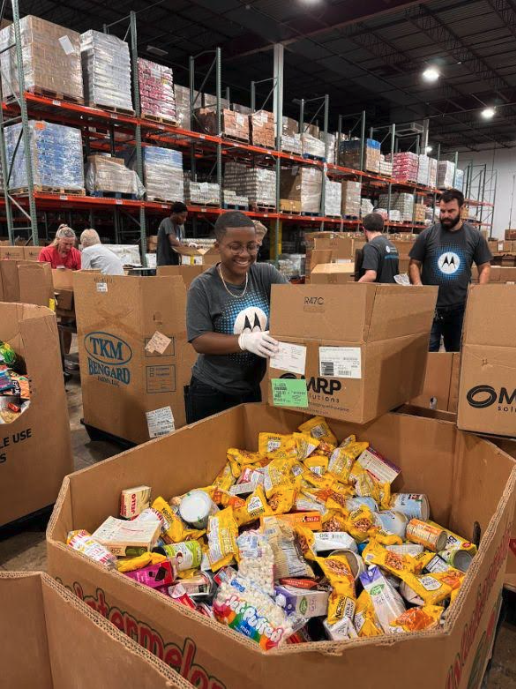 People in Motorola t-shirts working with boxes in a warehouse