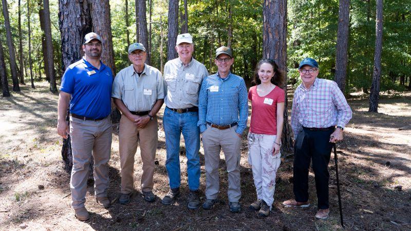 6 people standing in a forest