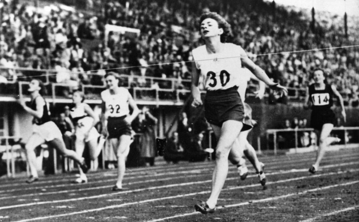 people running a race, crossing the finish line