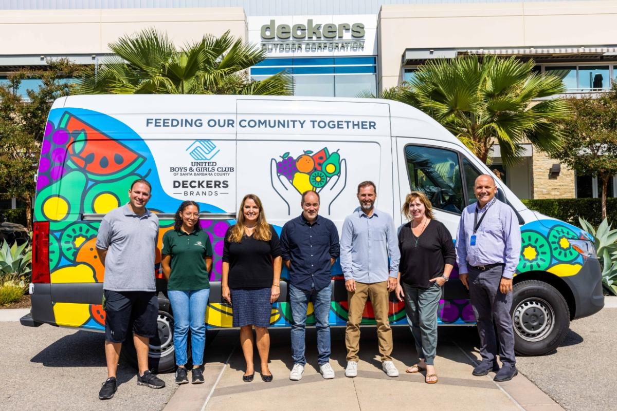 group of employees standing in front of van 