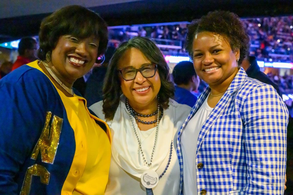 3 people smiling at a graduation