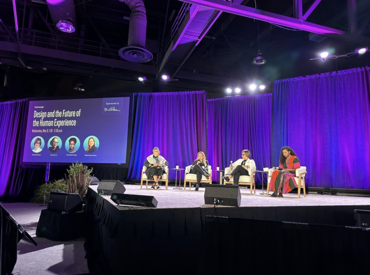 People sat on stage in front of an audience at the 2024 WELL Conference