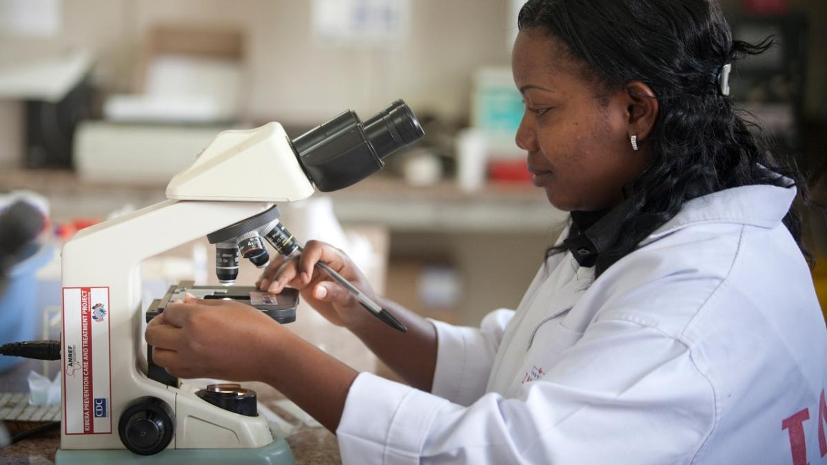 scientist using microscope