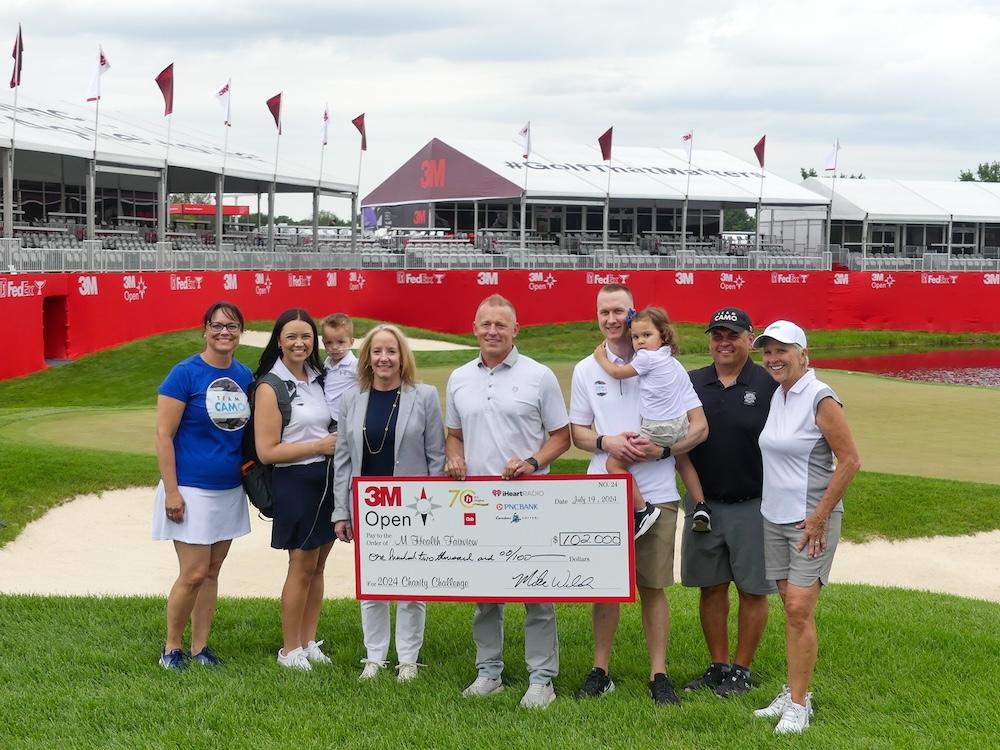 Cameron and group shown with foundation check for $102,000.