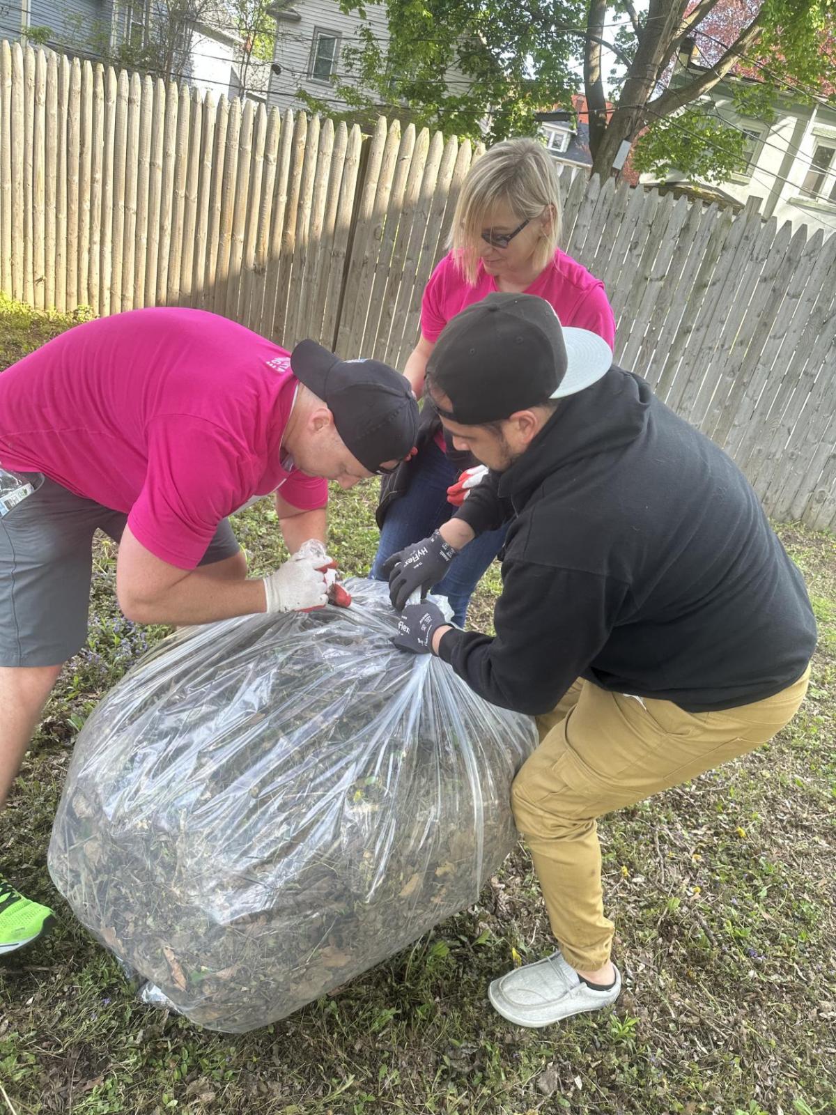 People bagging yard waste