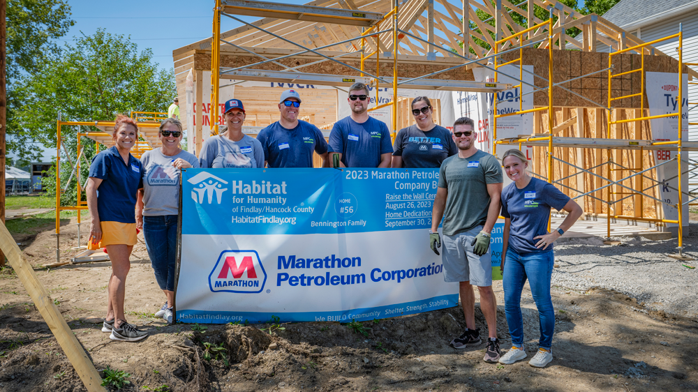 People standing in front of house framing