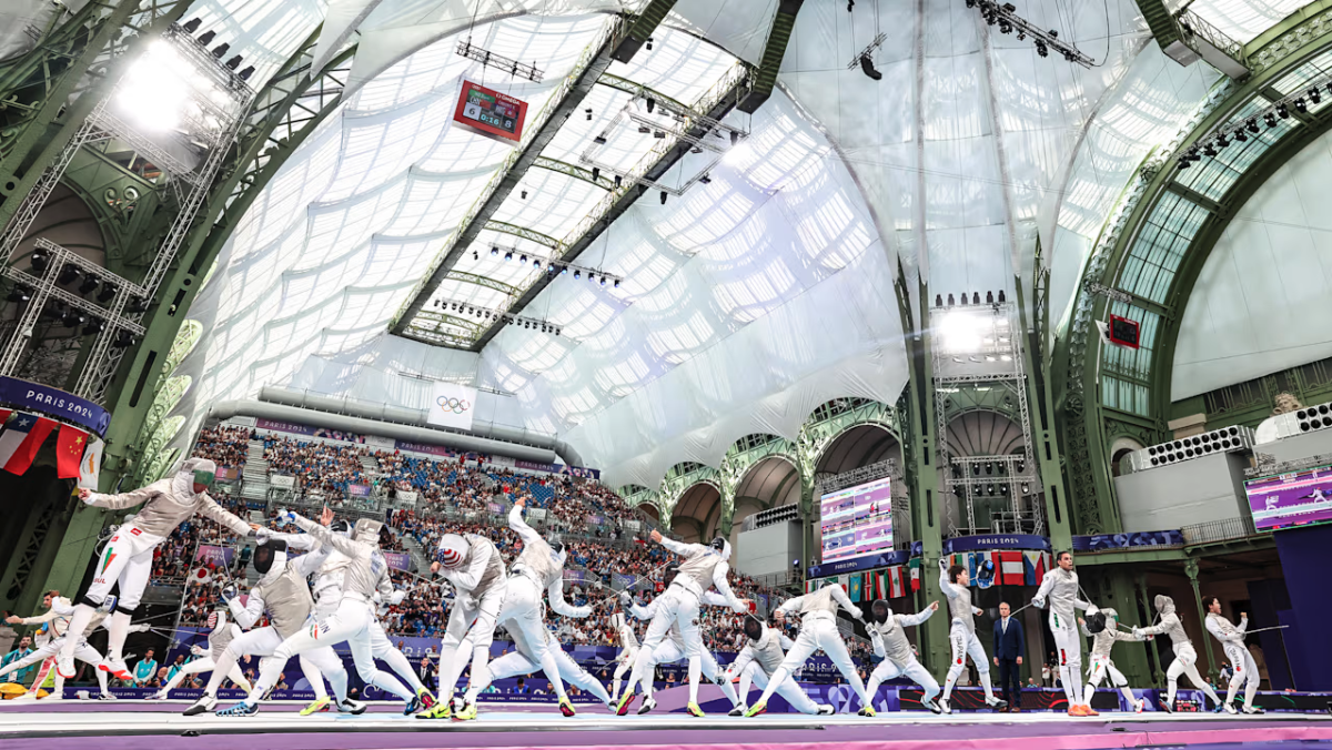 Olympic fencers inside a large building