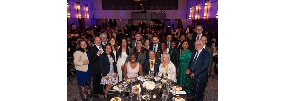 Steve Rusckowski with a group of people at a awards dinner