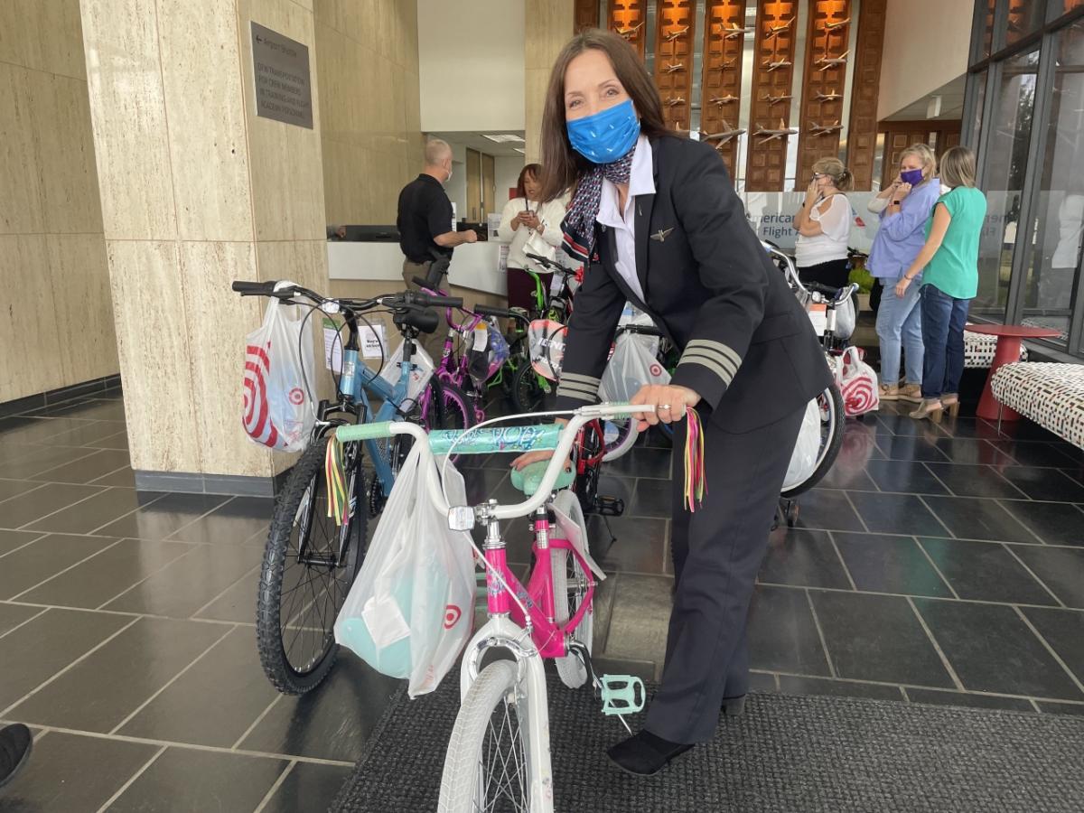 pilot posing with children's bike