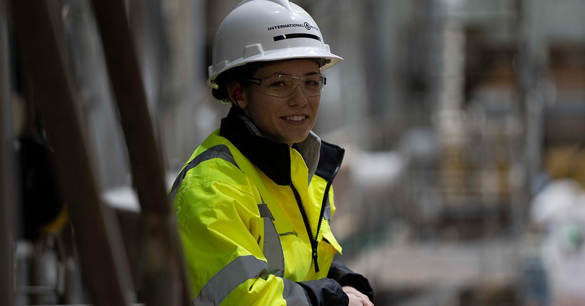 person in a helmet and safety jacket