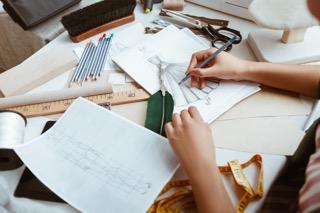 Tailor with notepad making sketches