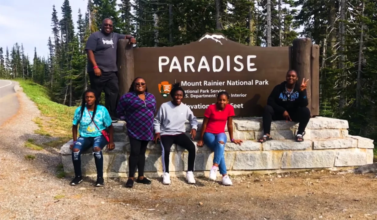 Photo of family posing outside Mount Rainier Park