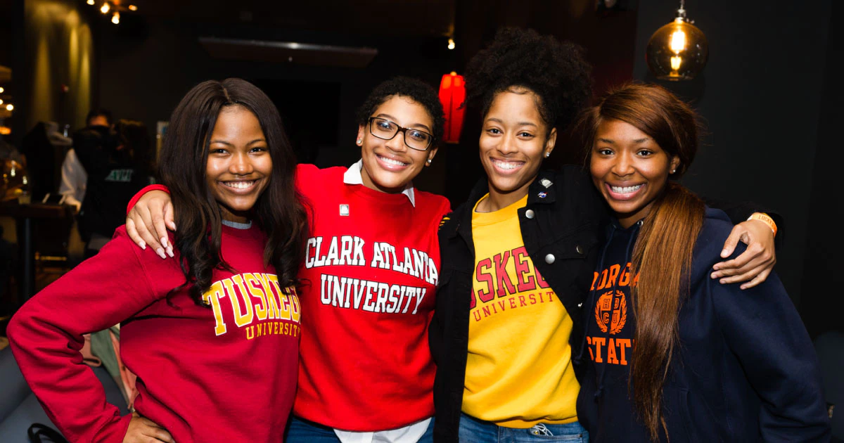 Women wearing college sweatshirts