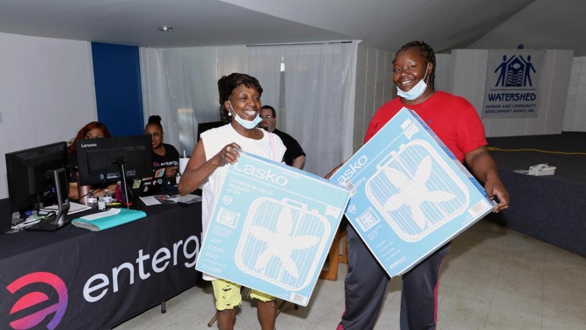 2 people holding box fans