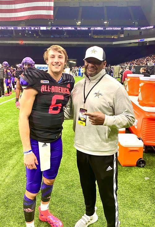 Anthony Williams standing with football player 