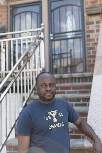 Resident standing in front of his home in NYC.