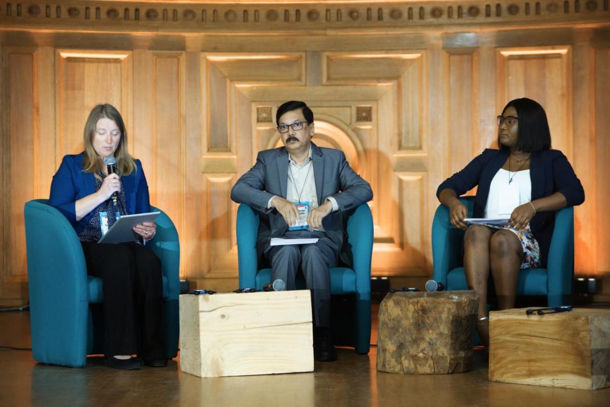 Dr. Jenna Jambeck, Dr. Shahriar Hossain, and Betty Osei Bonsu speaking togetheron stage.