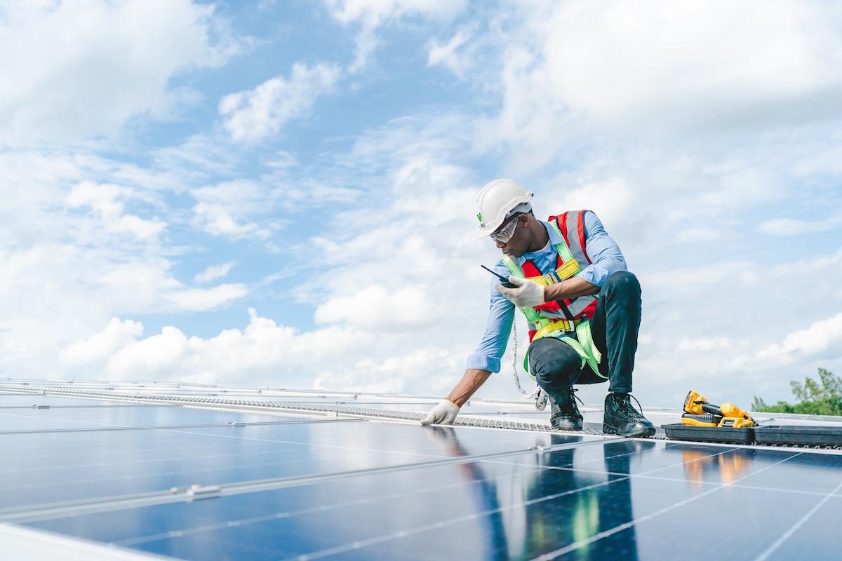 Wesco technician working on a solar panel array.