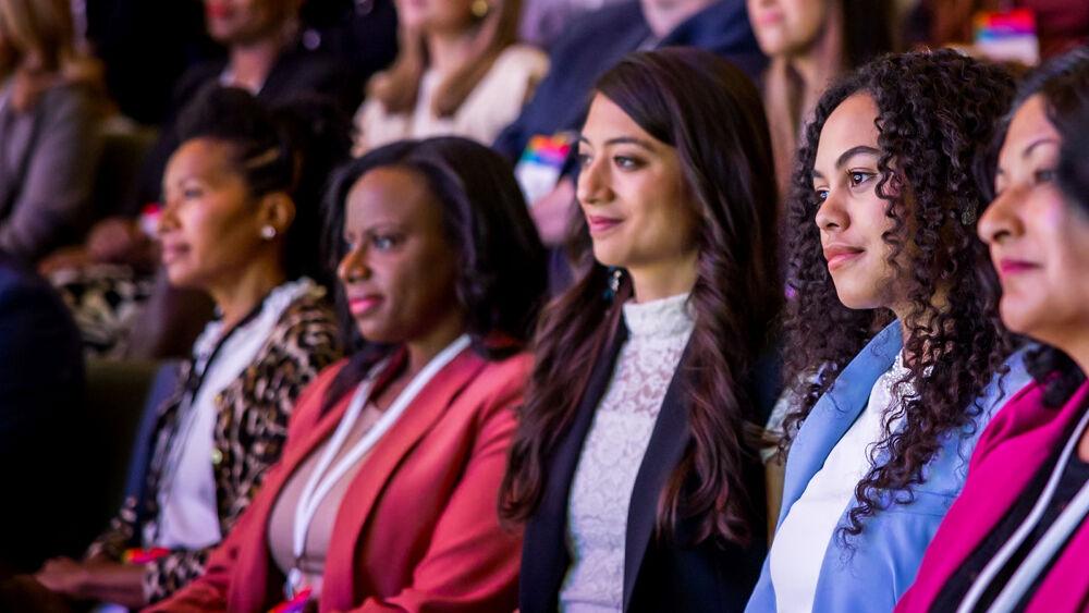 women sitting together in audience of project UP summit