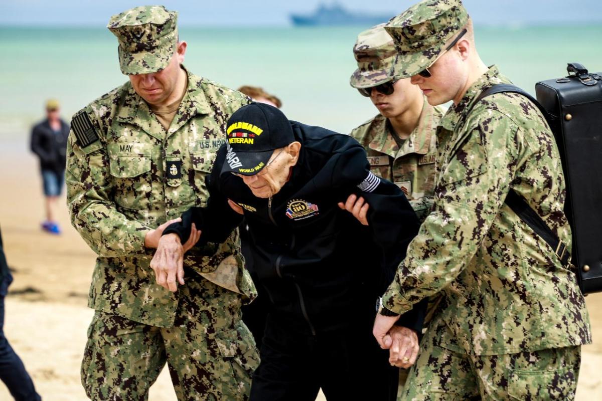 People assisting a veteran  