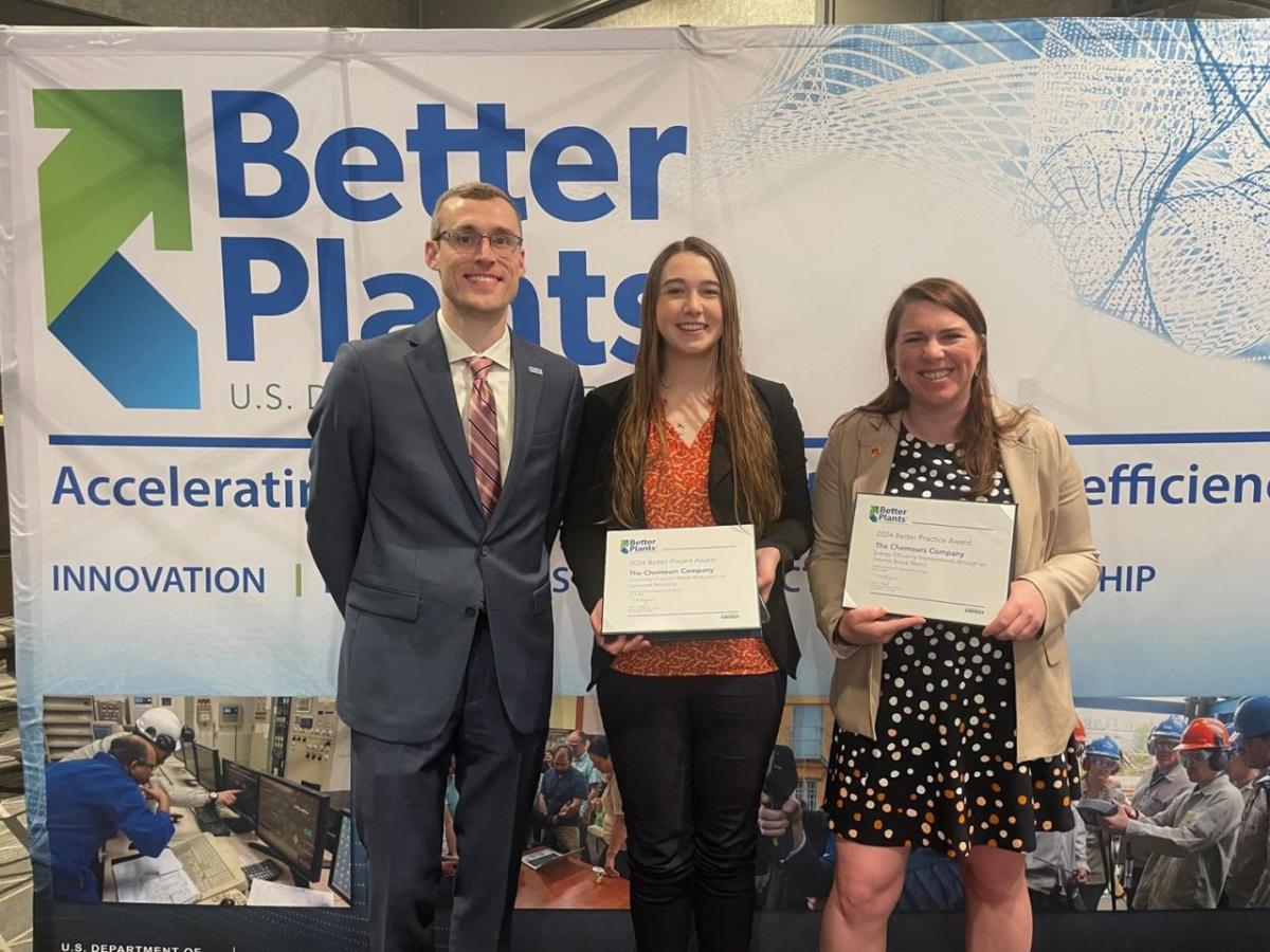 Catherine Collison and Josie Stoner holding awards next to a third person. A banner with "Better Plants" behind them.