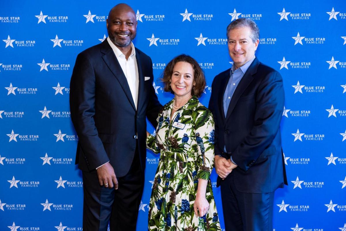 David L. Casey, Tapestry's Chief Diversity and Social Impact Officer; Kathy Roth-Douquet, Blue Star Families CEO; and Todd Kahn, COACH CEO standing in front of a blue backdrop