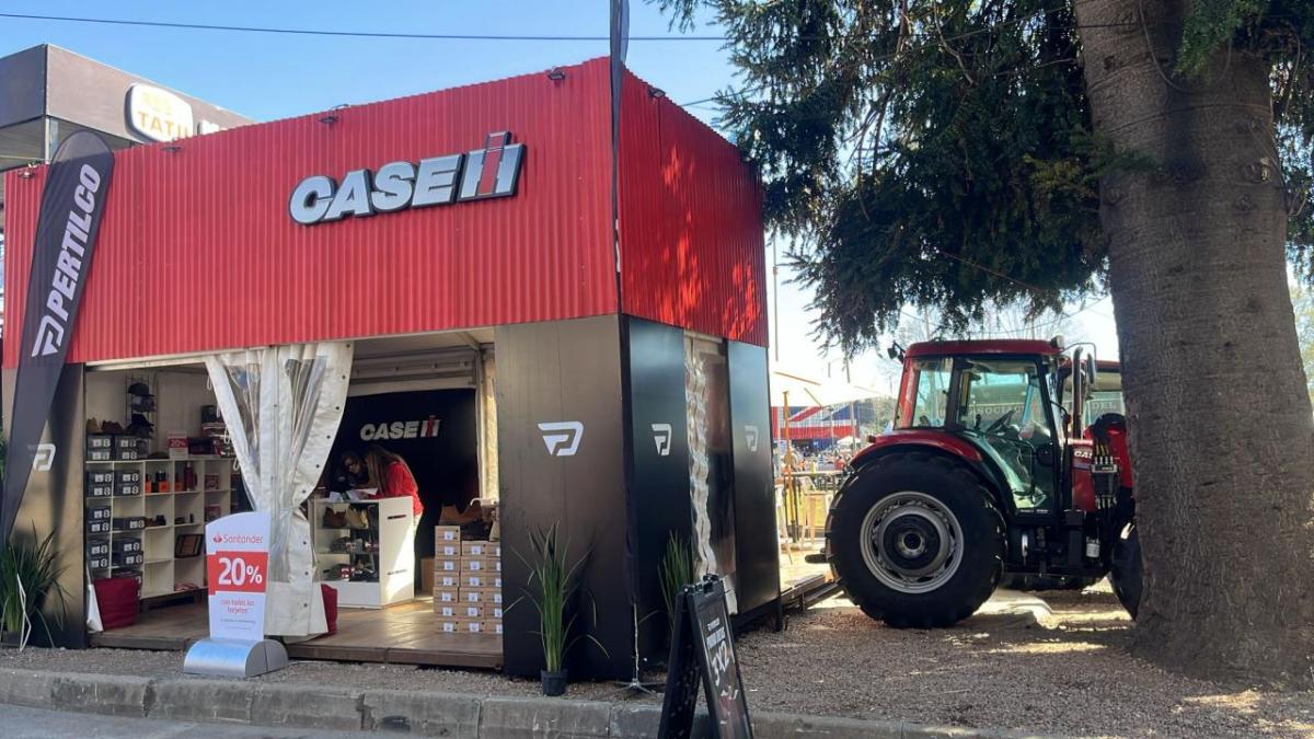 A Case IH sign above a small store with products on shelves. Tractor to the right.