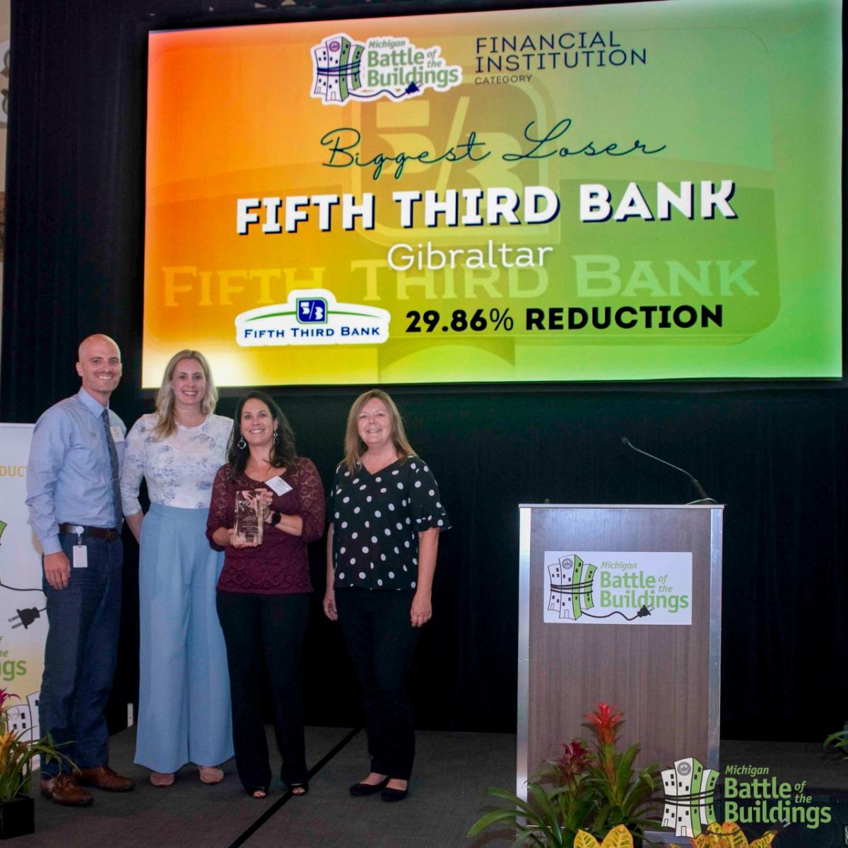 Group of people holding an award