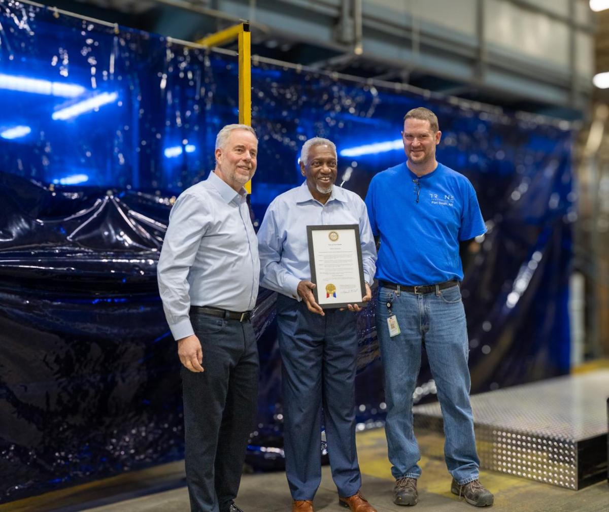 Ray Pittard, Trane Technologies Executive Vice President and Chief Officer, Integrated Supply Chain; Fort Smith Mayor George McGill and Carter Roth, Trane Fort Smith Plant Manager hold a proclamation declaring today (February 21) Trane Fort Smith Day