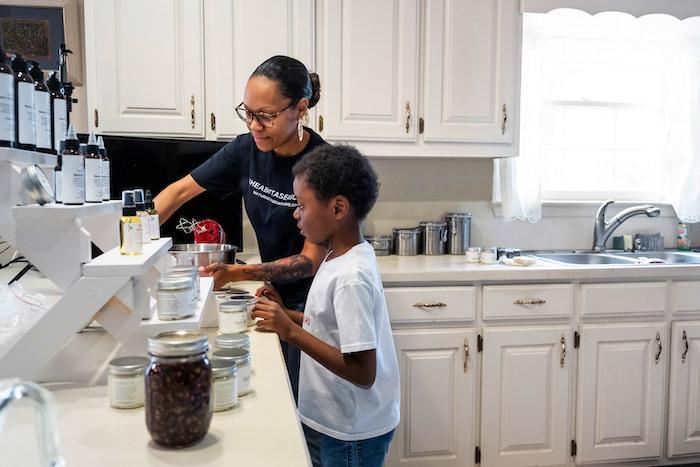 Jennifer Woodruff, Naturally Made with Love; Mom and her son packing a box.