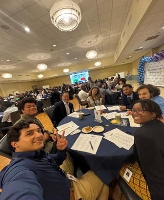 A group selfie taken around a table 