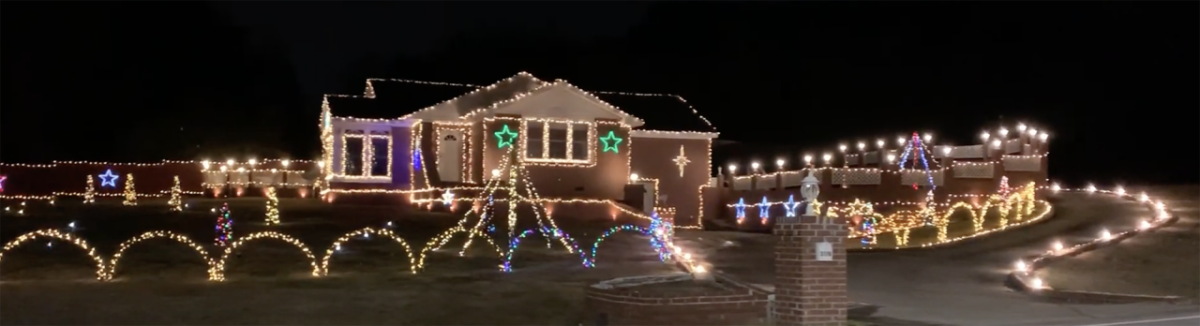 A gingerbread house lit at night in Jonesboro, GA.