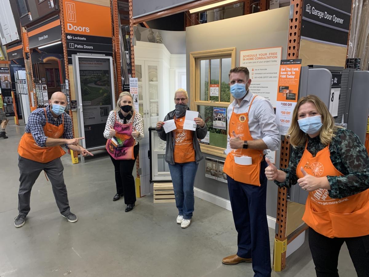 Kendra Byrd at her Home Depot store with four coworkers.