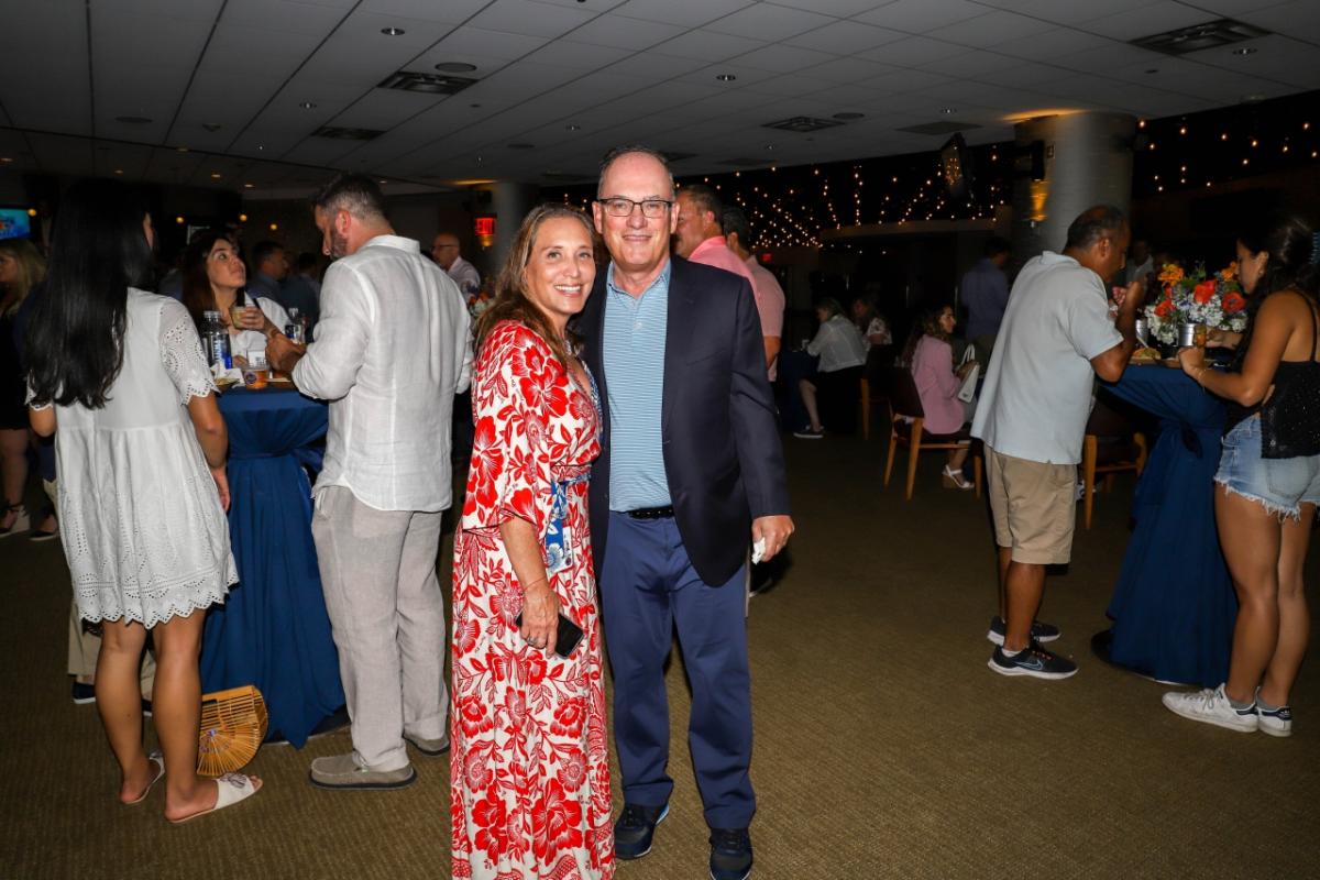 Two people at Homeruns & Highballs fundraiser